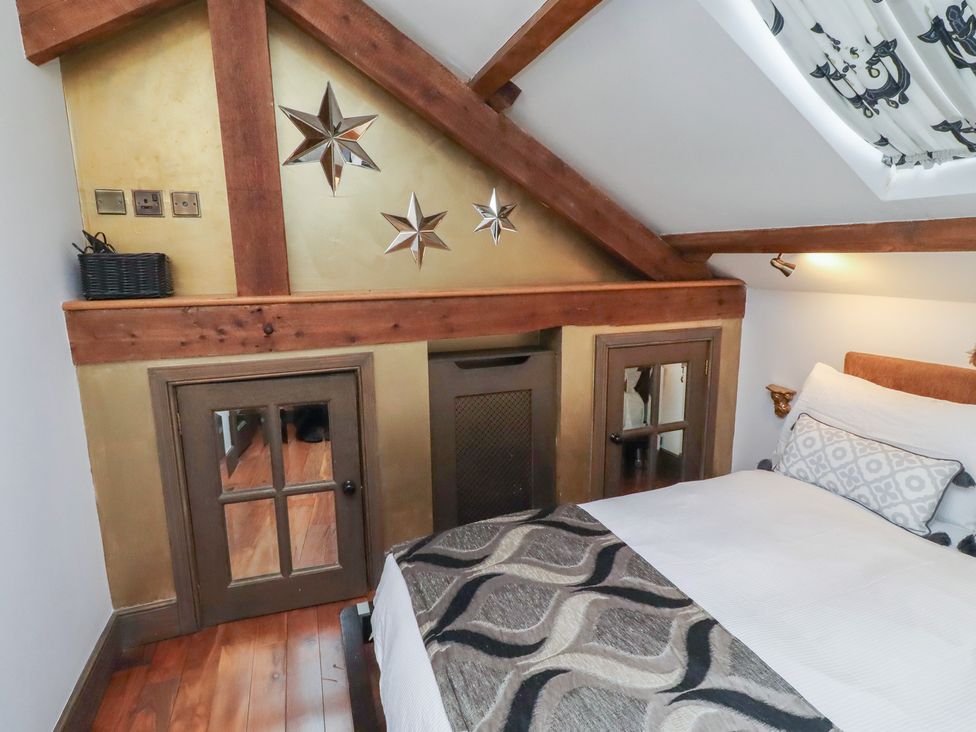 A bedroom with a bed and decorative stars at The Opulent in Hexham