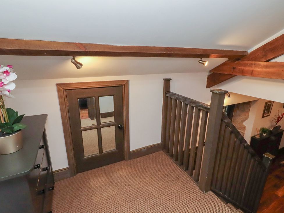 A landing with a door and plant at The Opulent in Hexham