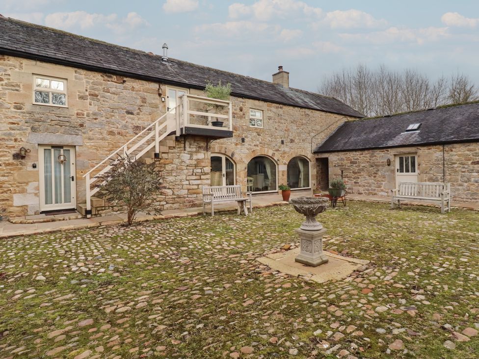An outdoor area with stone building and fountain at The Classic in Hexham