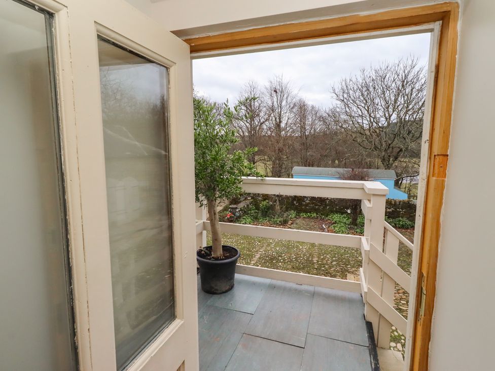 A balcony with a view of trees and a potted plant at The Classic in Hexham