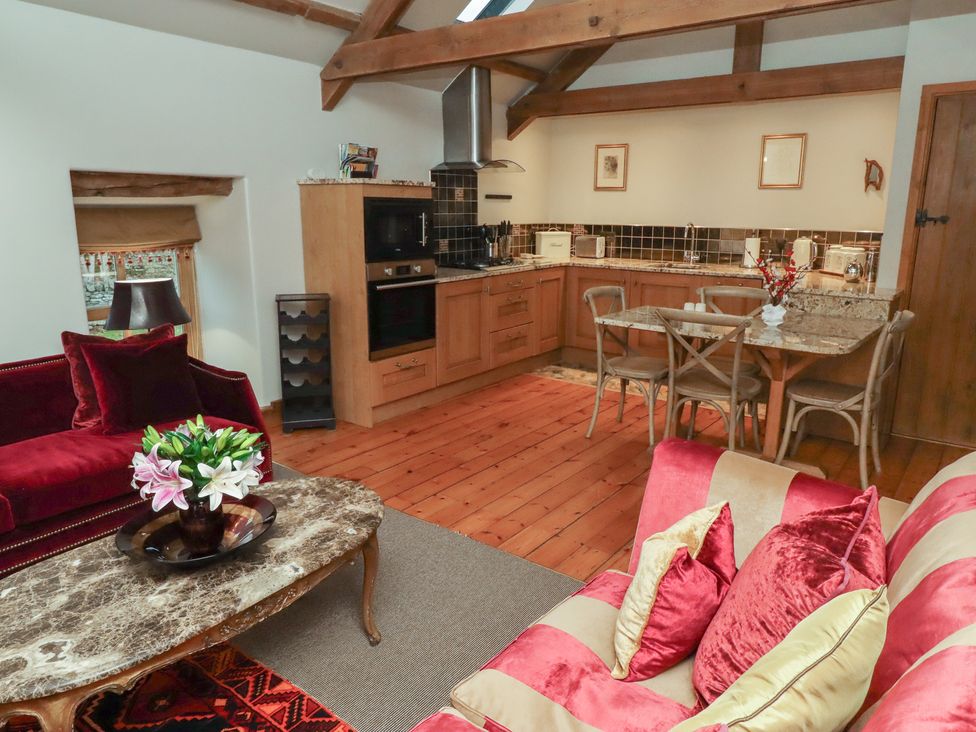 A living room with a kitchen area at The Classic in Hexham