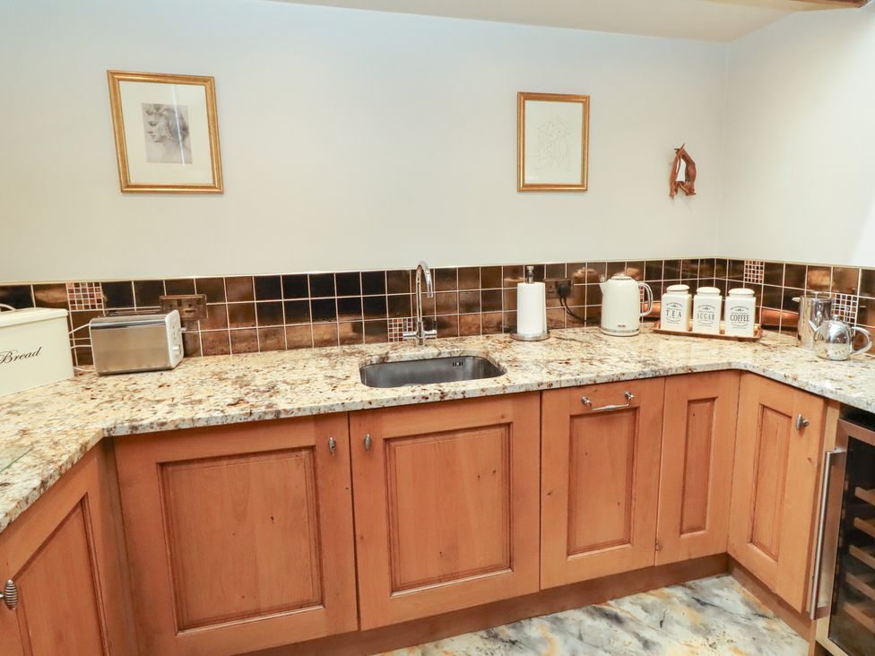 A kitchen with a sink and storage jars at The Classic in Hexham
