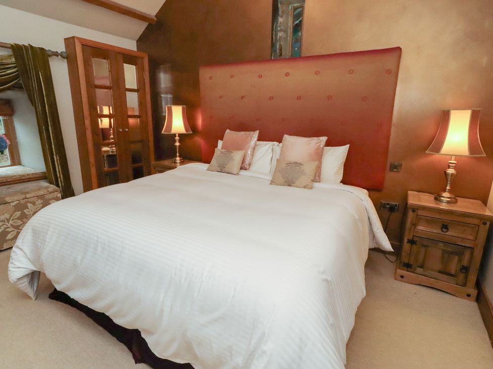 A bedroom with a bed and bedside tables at The Classic in Hexham