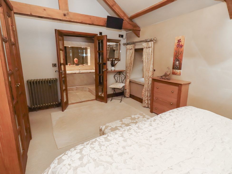 A bedroom with a bed and dresser at The Classic in Hexham