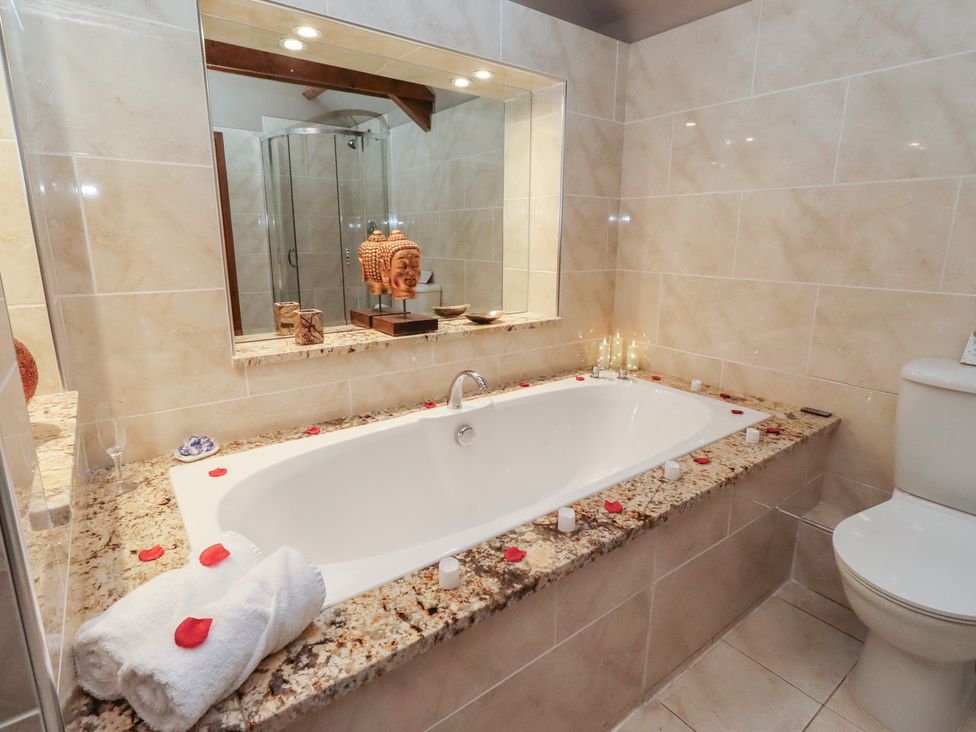 A bathroom featuring a bathtub and decorative items at The Classic in Hexham