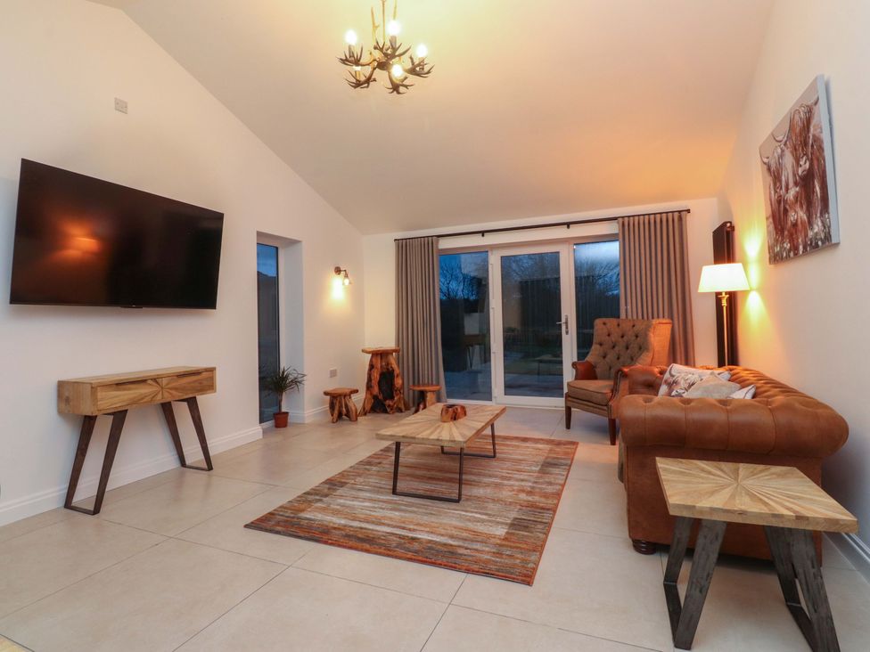A living room with a television and sofa at The Farm House in Skipton