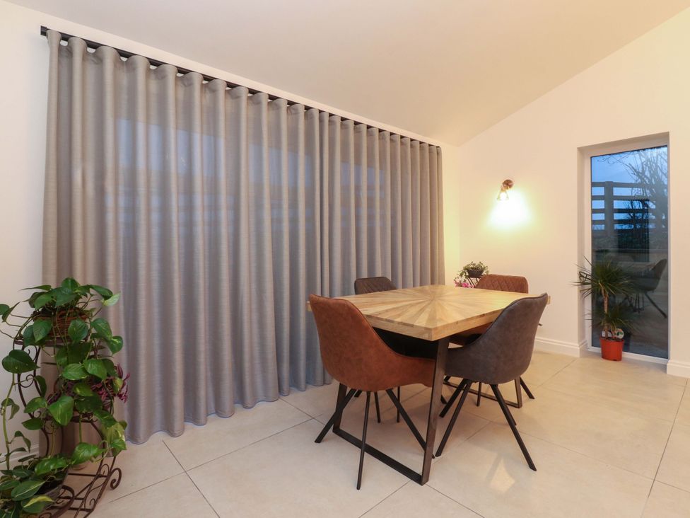 A dining room with a table and chairs at The Farm House in Skipton