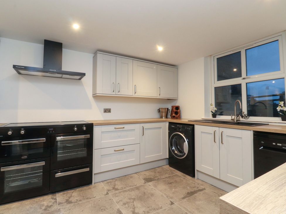 A kitchen with cabinets and appliances at The Farm House in Skipton