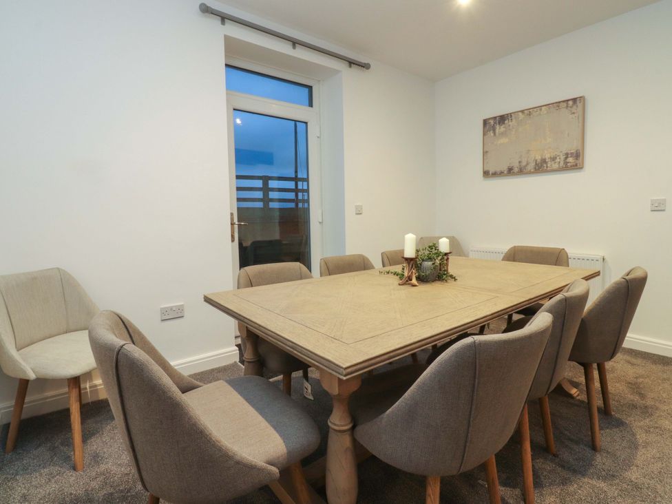 A dining room with a table and chairs at The Farm House in Skipton