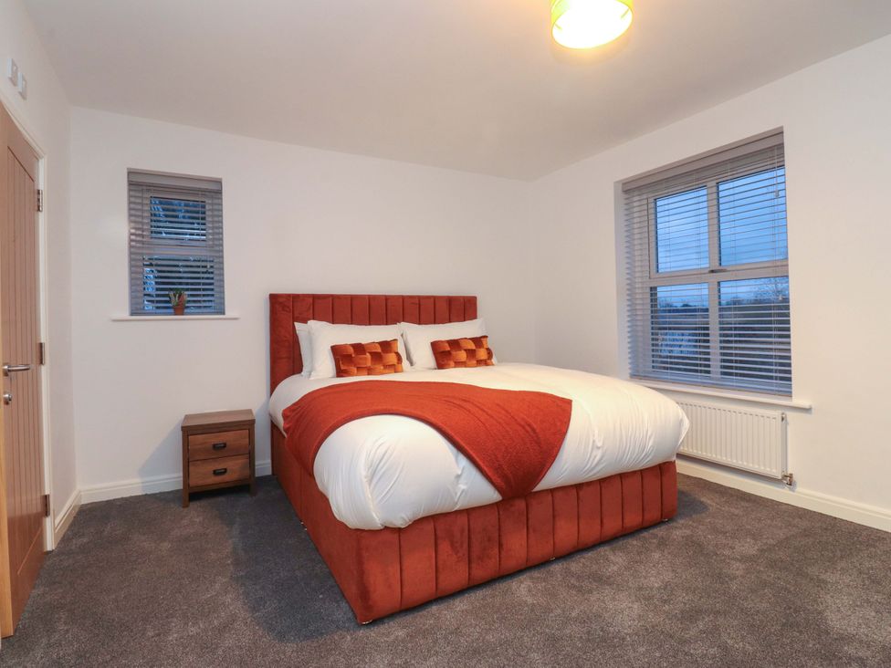 A bedroom with a bed and nightstand at The Farm House in Skipton