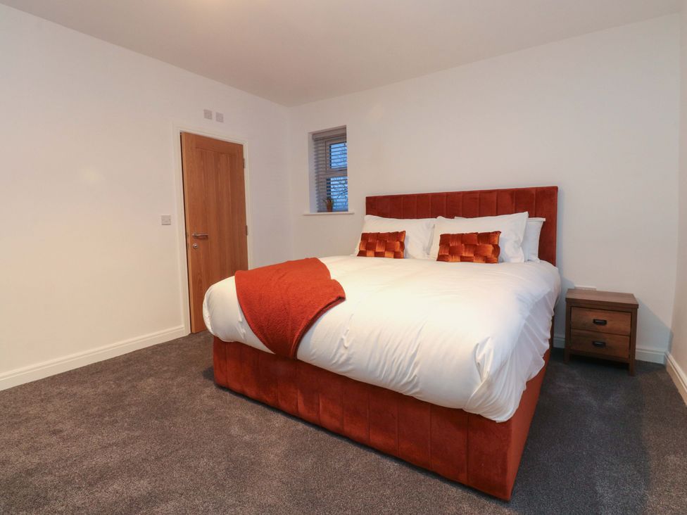 A bedroom with a bed and nightstand at The Farm House in Skipton
