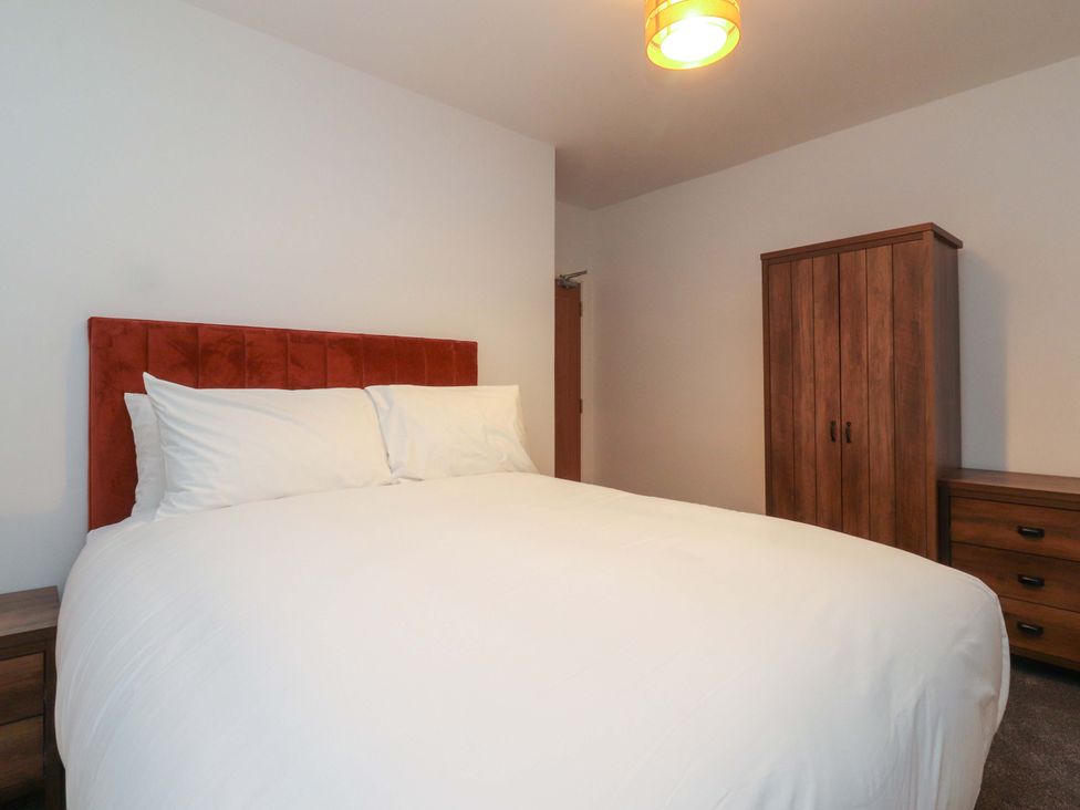 A bedroom with a bed and furniture at The Farm House in Skipton