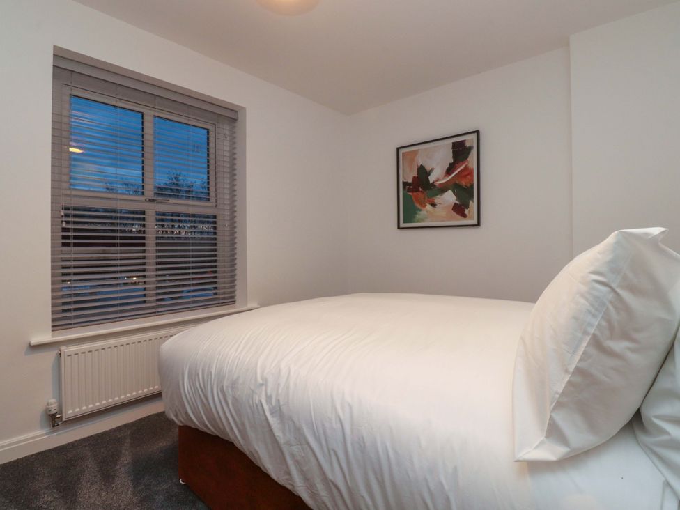 A bedroom with a bed and a window at The Farm House in Skipton