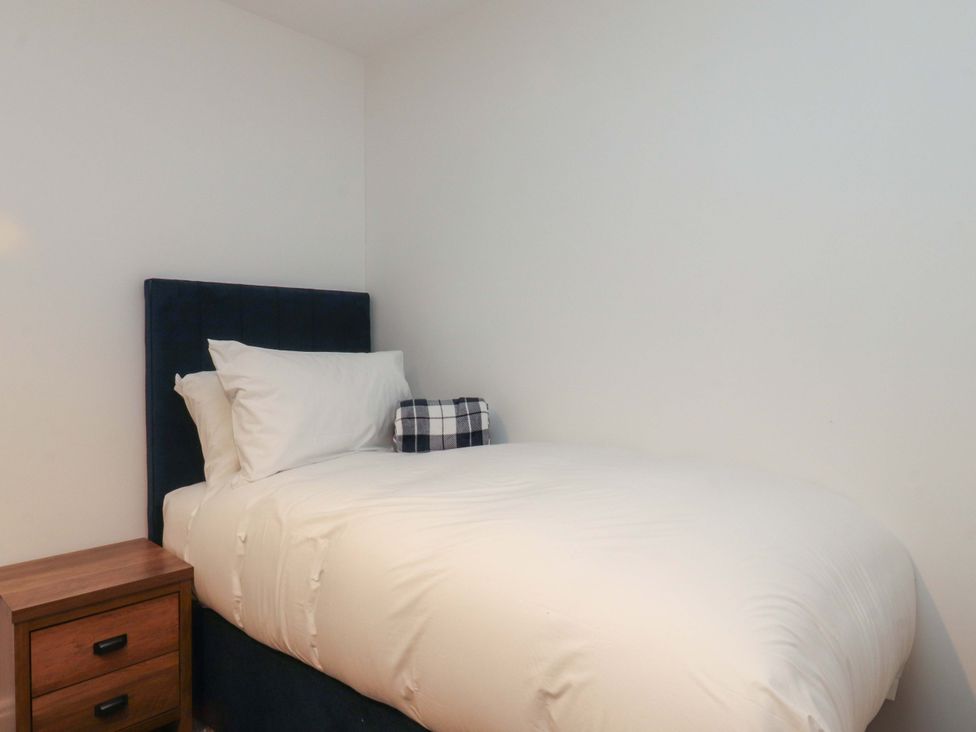 A bedroom with a bed and nightstand at The Farm House in Skipton
