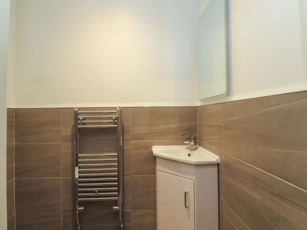 A bathroom with a sink and towel radiator at The Farm House in Skipton