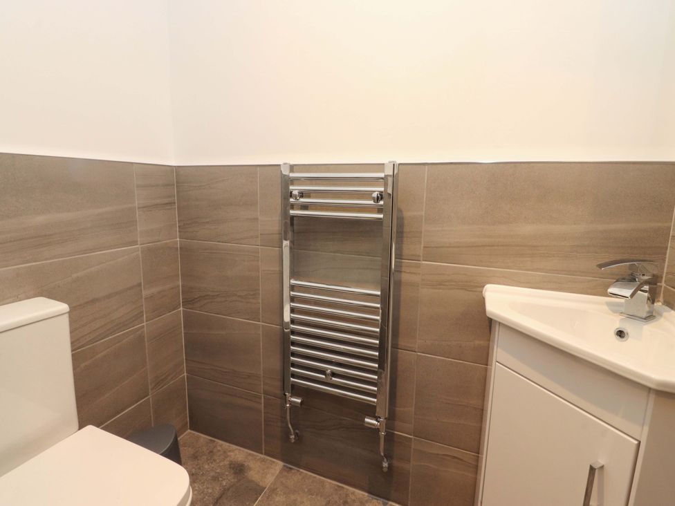 A bathroom with a toilet and sink at The Farm House in Skipton