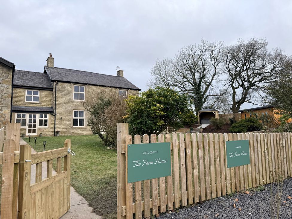 An outdoor view of The Farm House with a gate and fence in Wigglesworth near Settle
