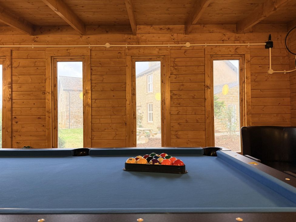A game room with a pool table at The Farm House in Wigglesworth near Settle