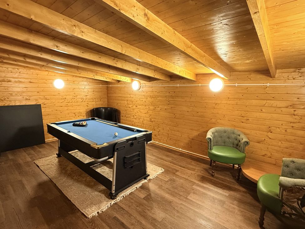A snug with a pool table and seating at The Farm House in Wigglesworth near Settle