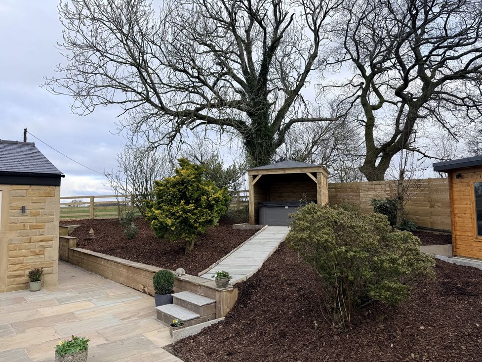 A garden with a pathway and shed at The Farm House in Wigglesworth near Settle