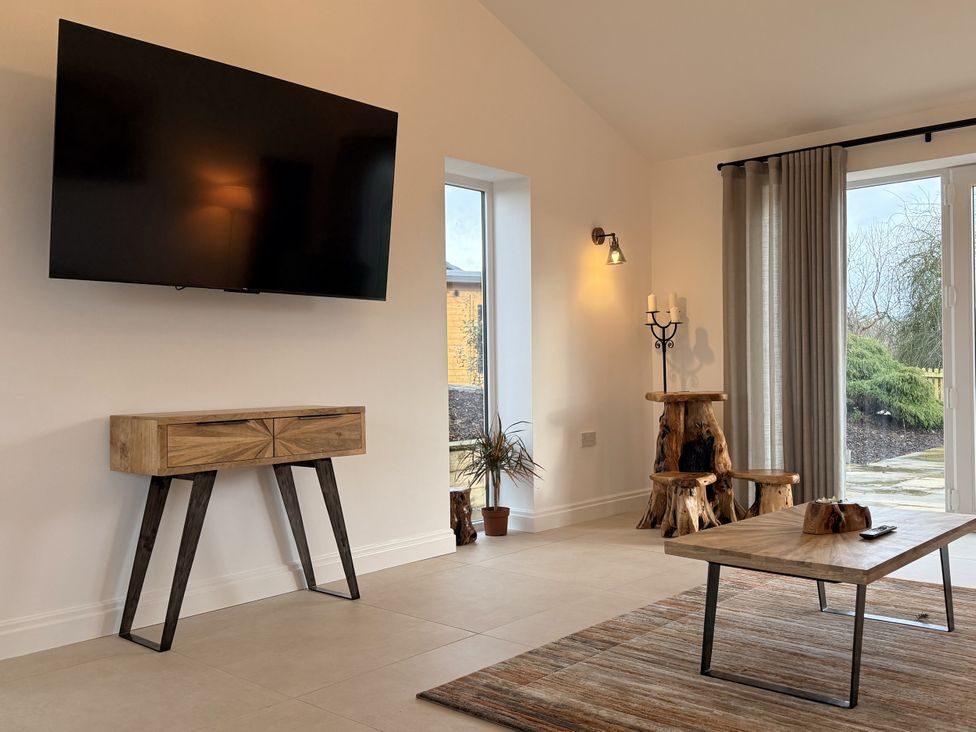 A living room with a television and a coffee table at The Farm House in Wigglesworth near Settle