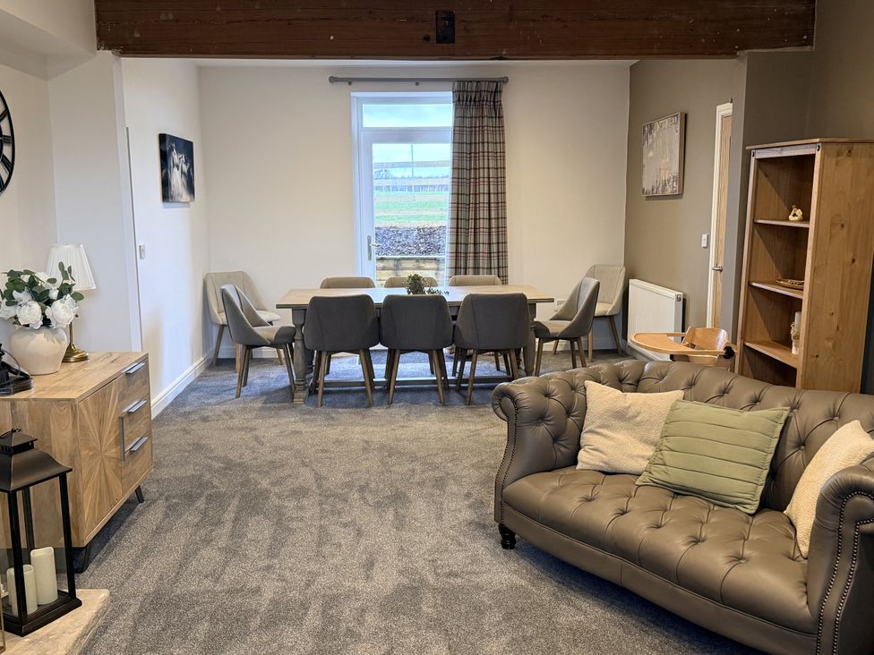 A dining room with a table and chairs at The Farm House in Wigglesworth near Settle