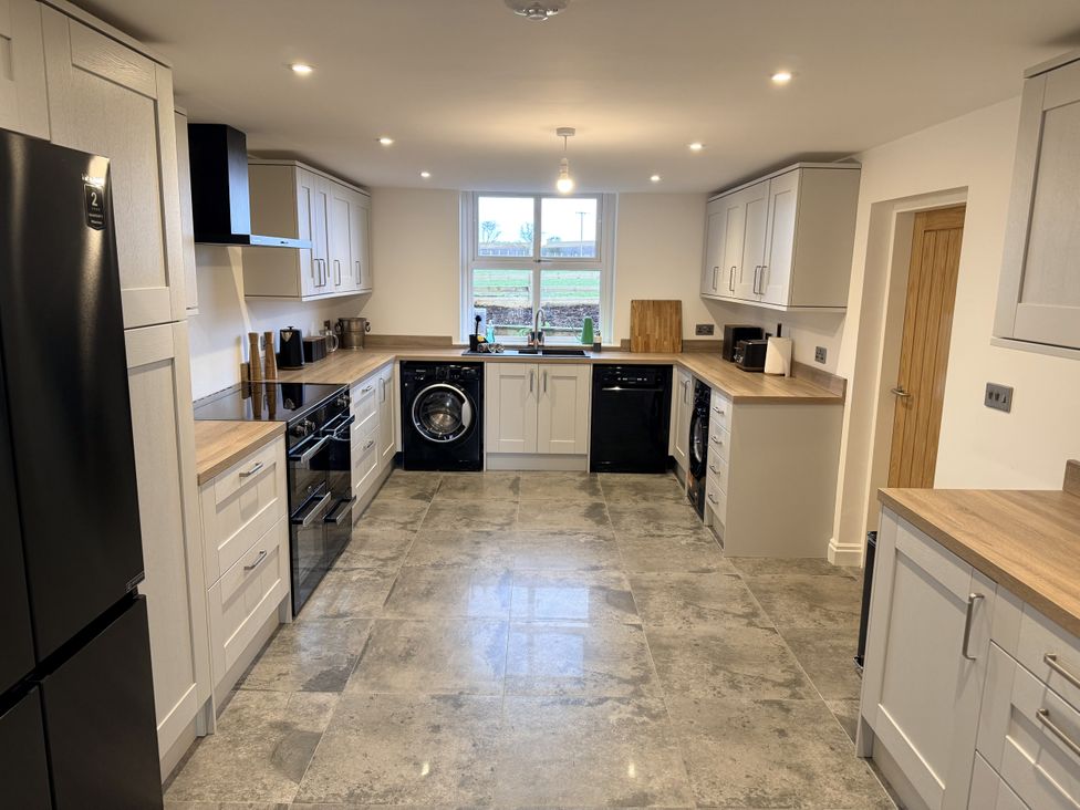 A kitchen with appliances and cabinets at The Farm House in Wigglesworth near Settle