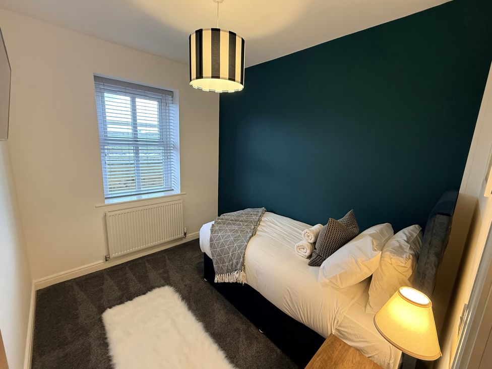 A bedroom with a bed and lamp at The Farm House in Wigglesworth near Settle