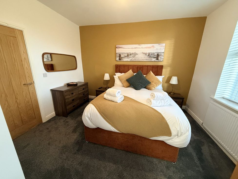A bedroom with a bed and dresser at The Farm House in Wigglesworth near Settle