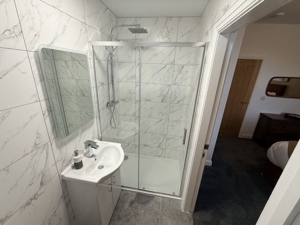 A bathroom with a shower and sink at The Farm House in Wigglesworth near Settle