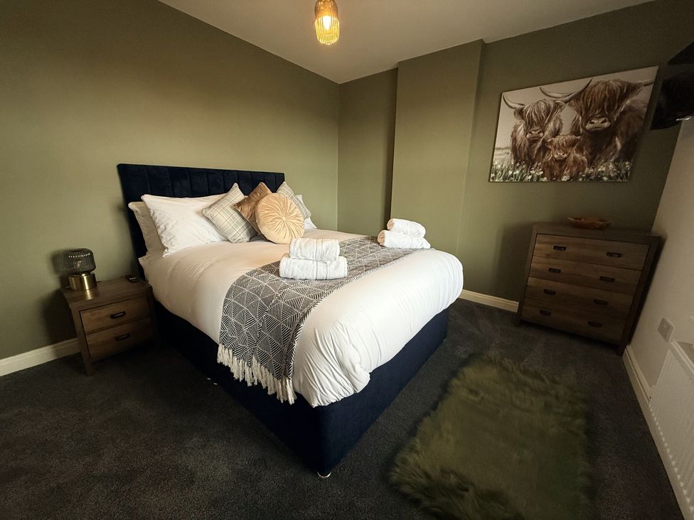 A bedroom with a bed and bedside table at The Farm House Wigglesworth near Settle