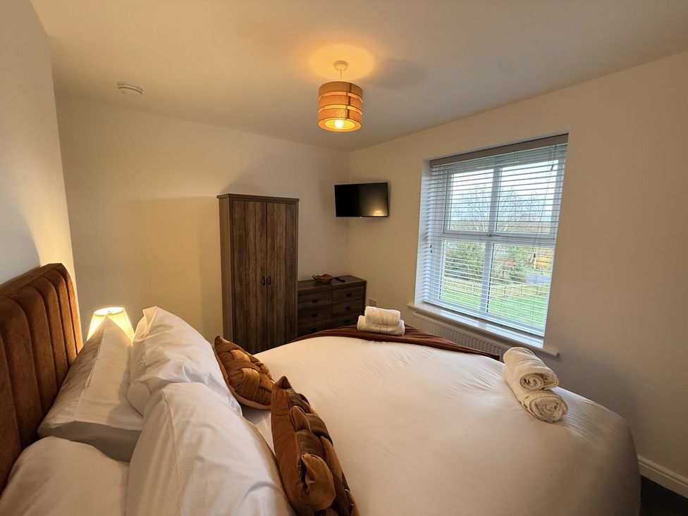A bedroom with a bed and wardrobe at The Farm House in Wigglesworth near Settle