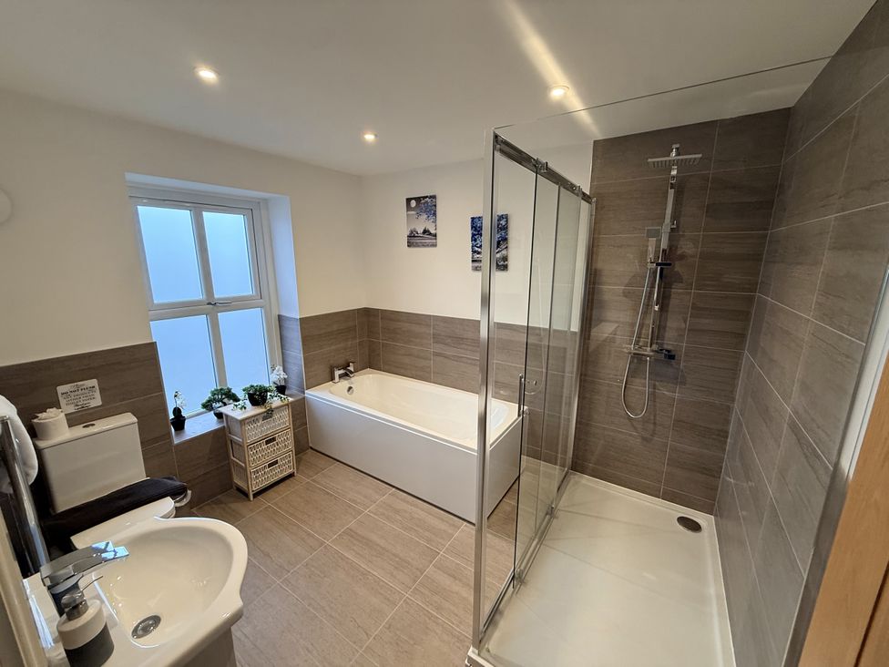 A bathroom with a shower and bathtub at The Farm House in Wigglesworth near Settle