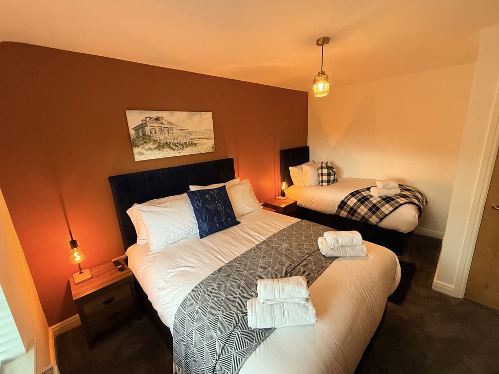 A bedroom with two beds and a painting at The Farm House in Wigglesworth near Settle