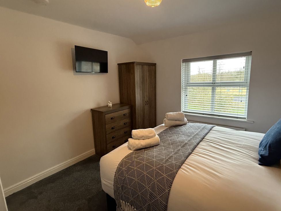 A bedroom with a bed and wardrobe at The Farm House in Wigglesworth near Settle