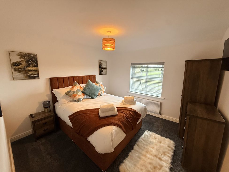 A bedroom with a bed and nightstand at The Farm House in Wigglesworth near Settle