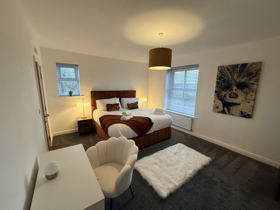 A bedroom with a bed and a chair at The Farm House in Wigglesworth near Settle