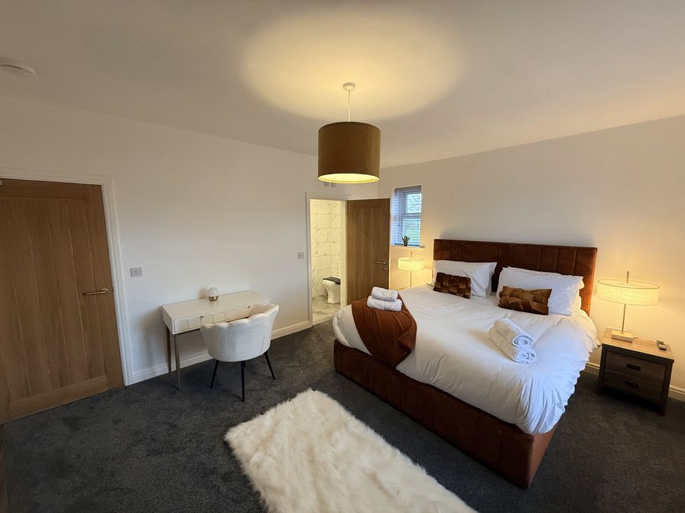 A bedroom with a bed and desk at The Farm House in Wigglesworth near Settle
