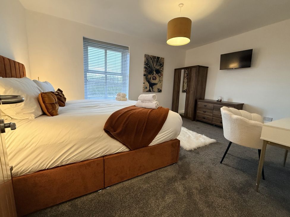 A bedroom with a bed and desk at The Farm House in Wigglesworth near Settle