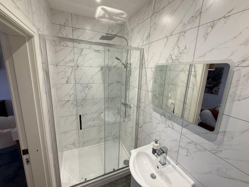 A bathroom with a shower and sink at The Farm House in Wigglesworth near Settle