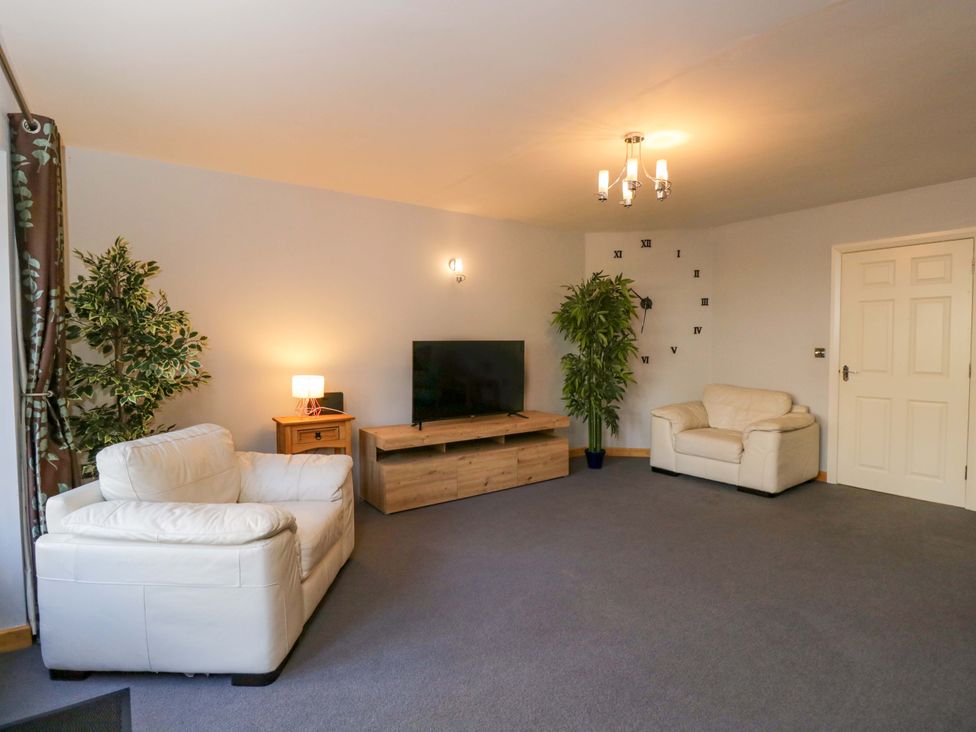 A living room with a sofa and television at Lady Of Lourdes in Whitchurch, Herefordshire