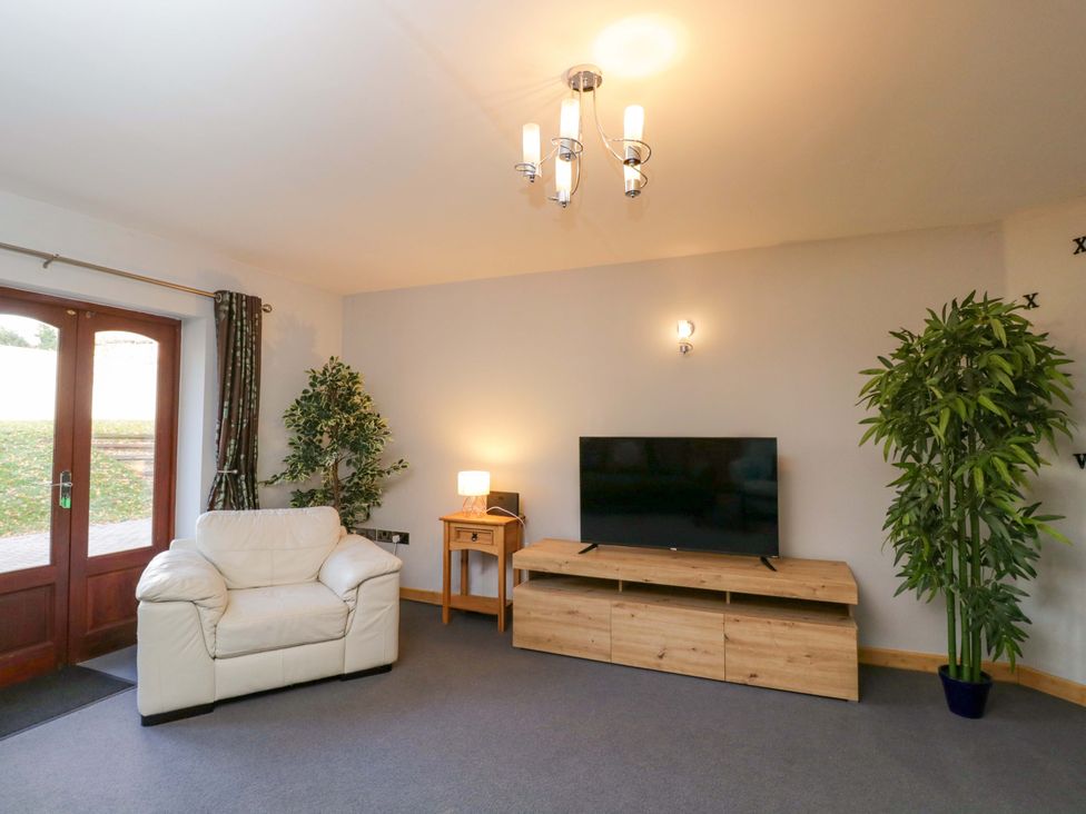 A living room with a sofa and television at Lady Of Lourdes in Whitchurch, Herefordshire