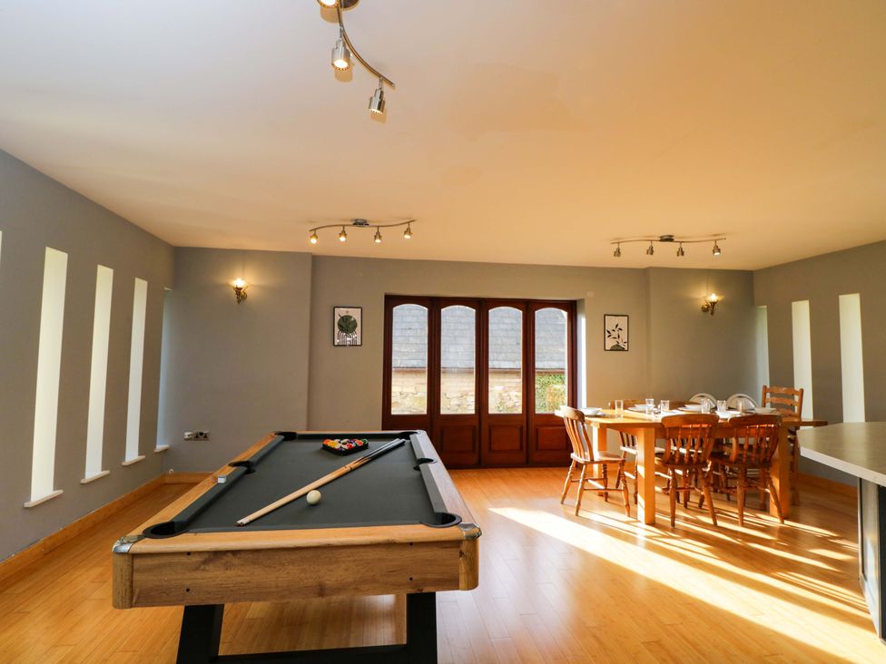A game room with a pool table and dining area at Lady Of Lourdes in Whitchurch, Herefordshire