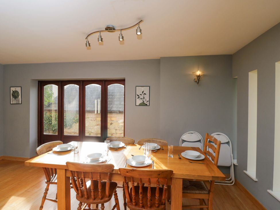 A dining room with a table set for meals at Lady Of Lourdes in Whitchurch, Herefordshire