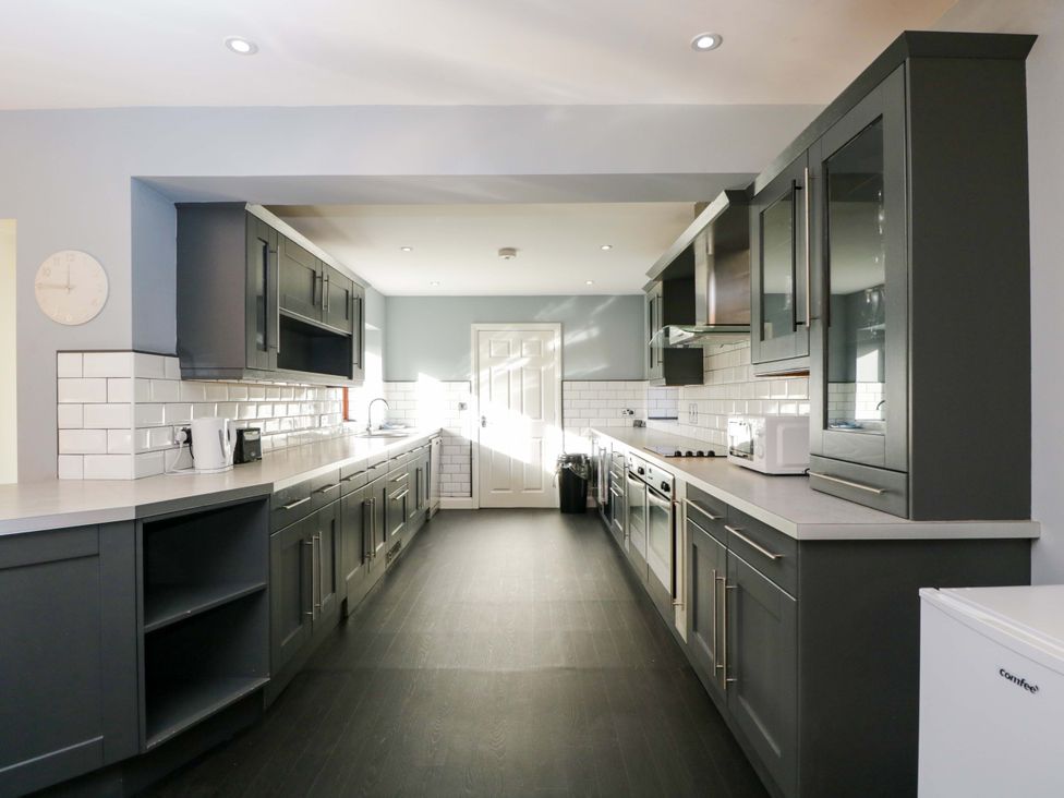 A kitchen with cabinets, sink, and oven at Lady Of Lourdes in Whitchurch, Herefordshire