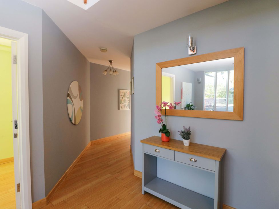 A hallway with a console table and mirror at Lady Of Lourdes Whitchurch, Herefordshire