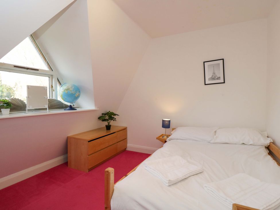 A bedroom with a bed and globe on a dresser at Lady Of Lourdes, Whitchurch, Herefordshire