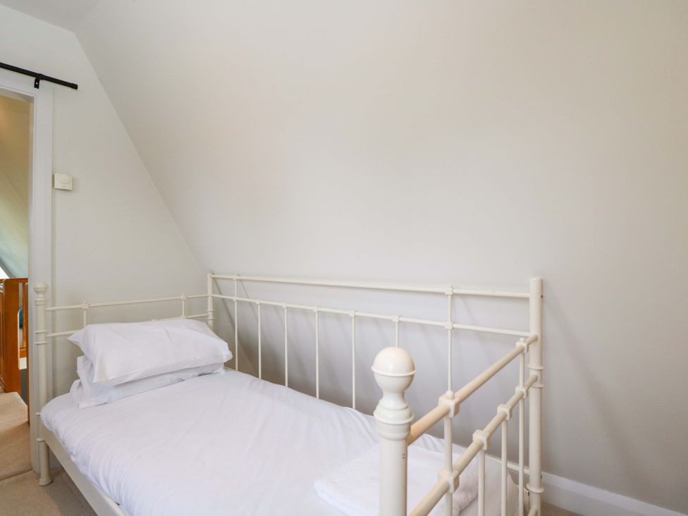 A bedroom with a single bed and pillows at Lady Of Lourdes in Whitchurch, Herefordshire