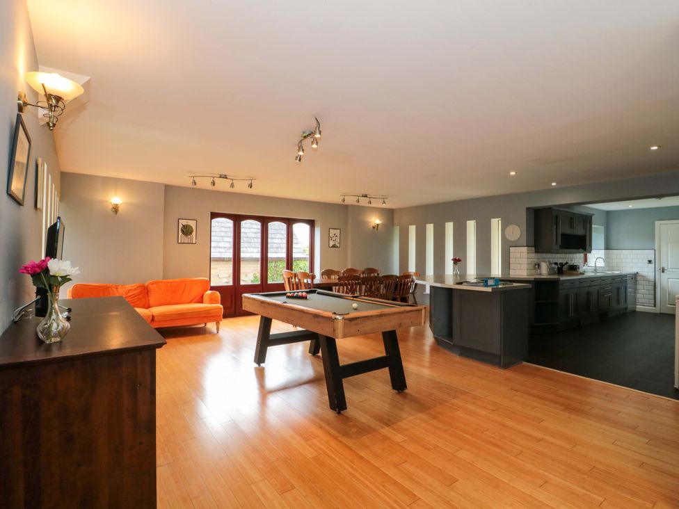 A living room with a sofa and pool table at Lady Of Lourdes in Whitchurch, Herefordshire