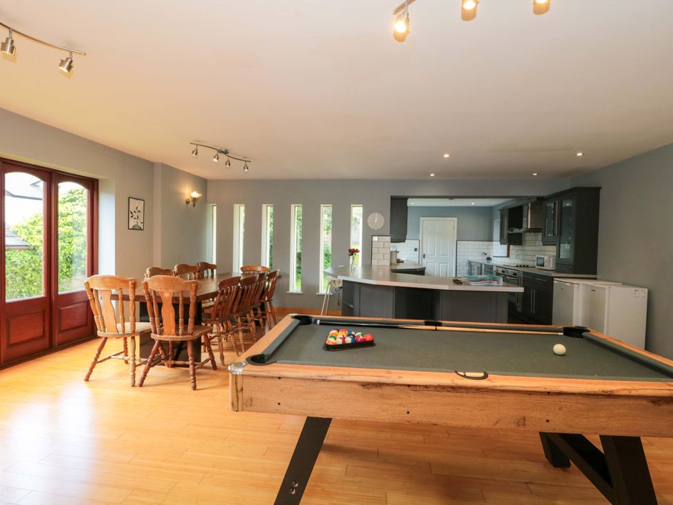 A kitchen with a pool table and dining area at Lady Of Lourdes in Whitchurch, Herefordshire